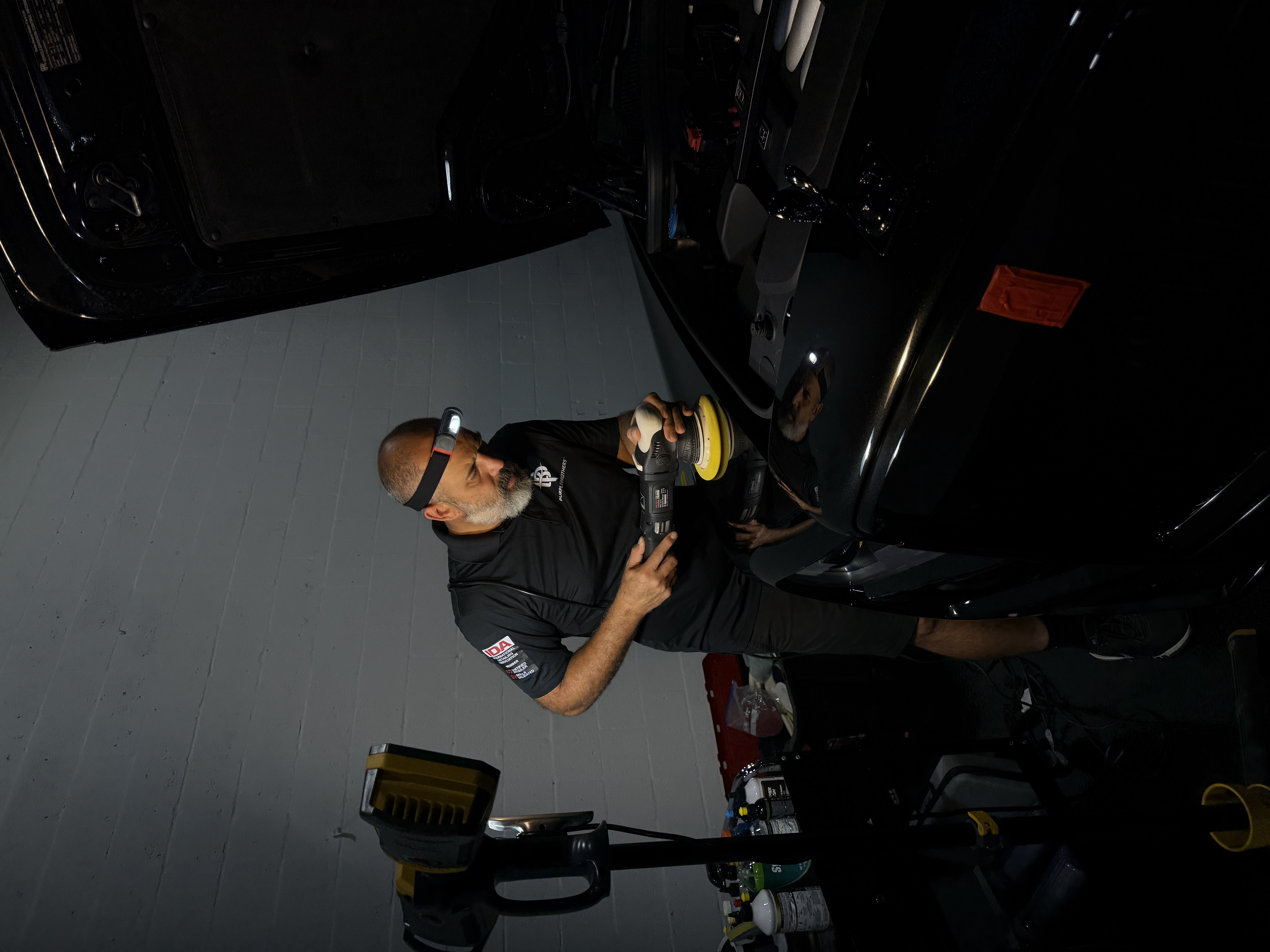 Angel Moreno performing precision paint correction on a Rolls Royce